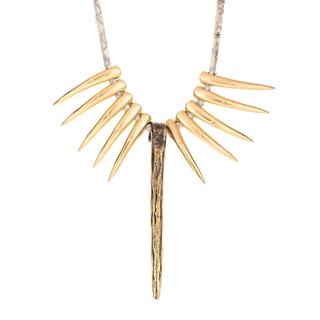 Necklace with golden fangs and nail-shaped bead
