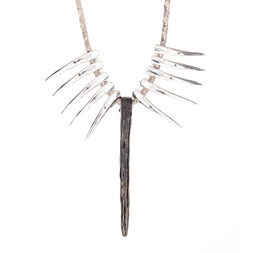Necklace with steel colored fangs and nail-shaped charm