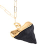 Original small shark tooth necklace finished in gold and black seen close-up
