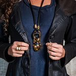Woman with Egyptian scarab necklace combined with leather jacket