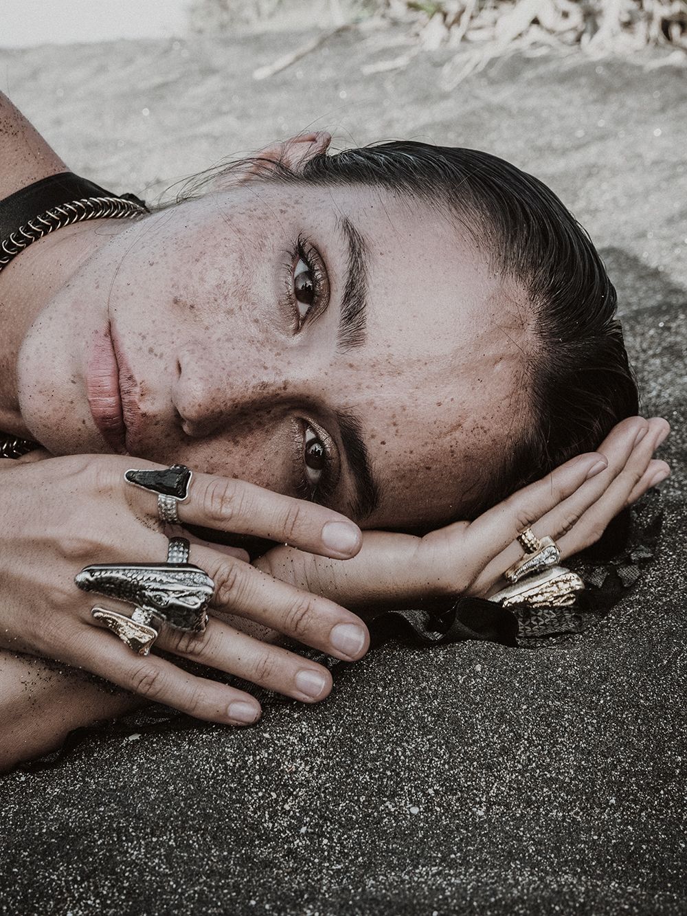 Woman with large and small crocodile head rings